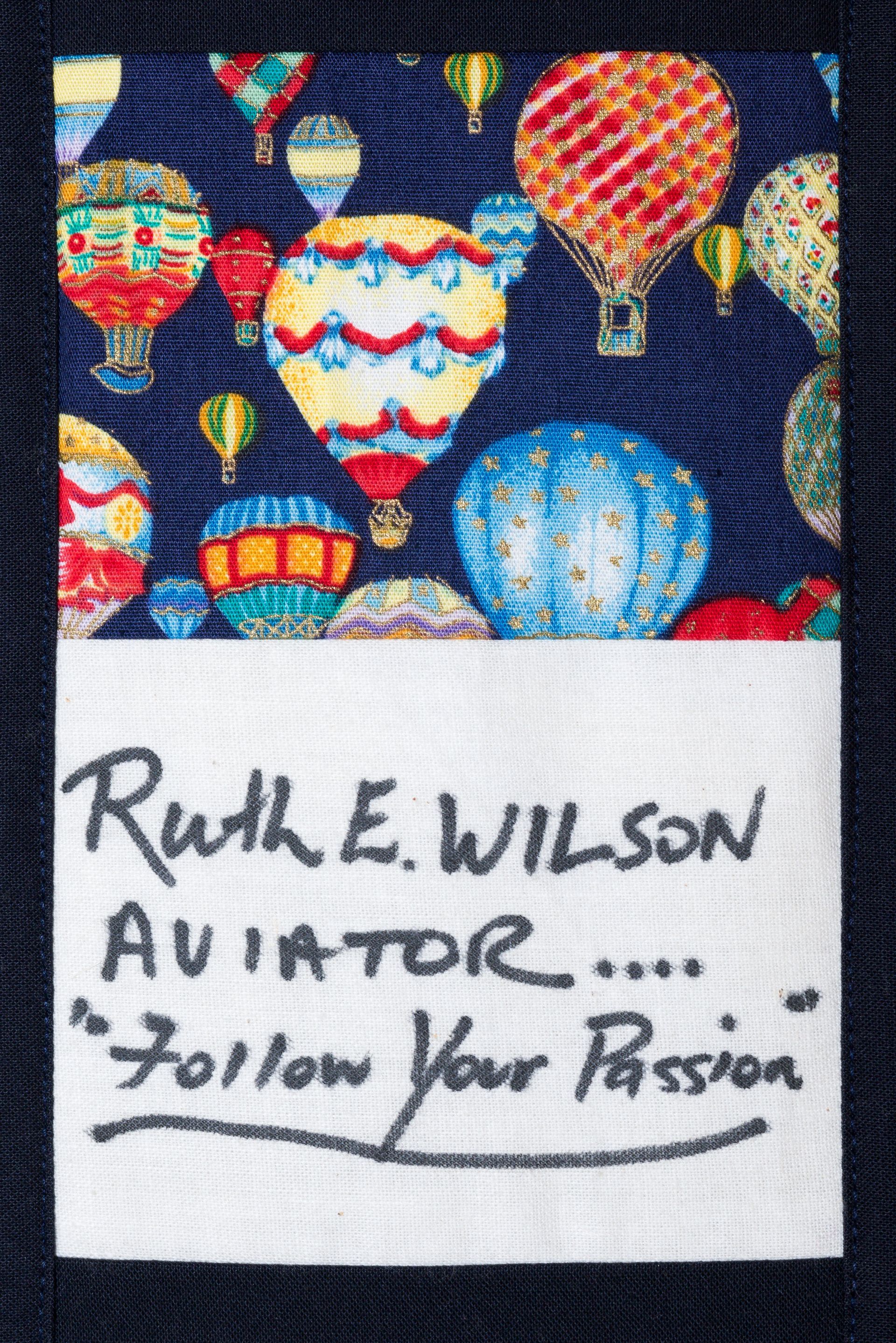 Patch with colorful hot-air balloons above a label reading “Ruth E. Wilson, Aviator, ‘Follow Your Passion’”