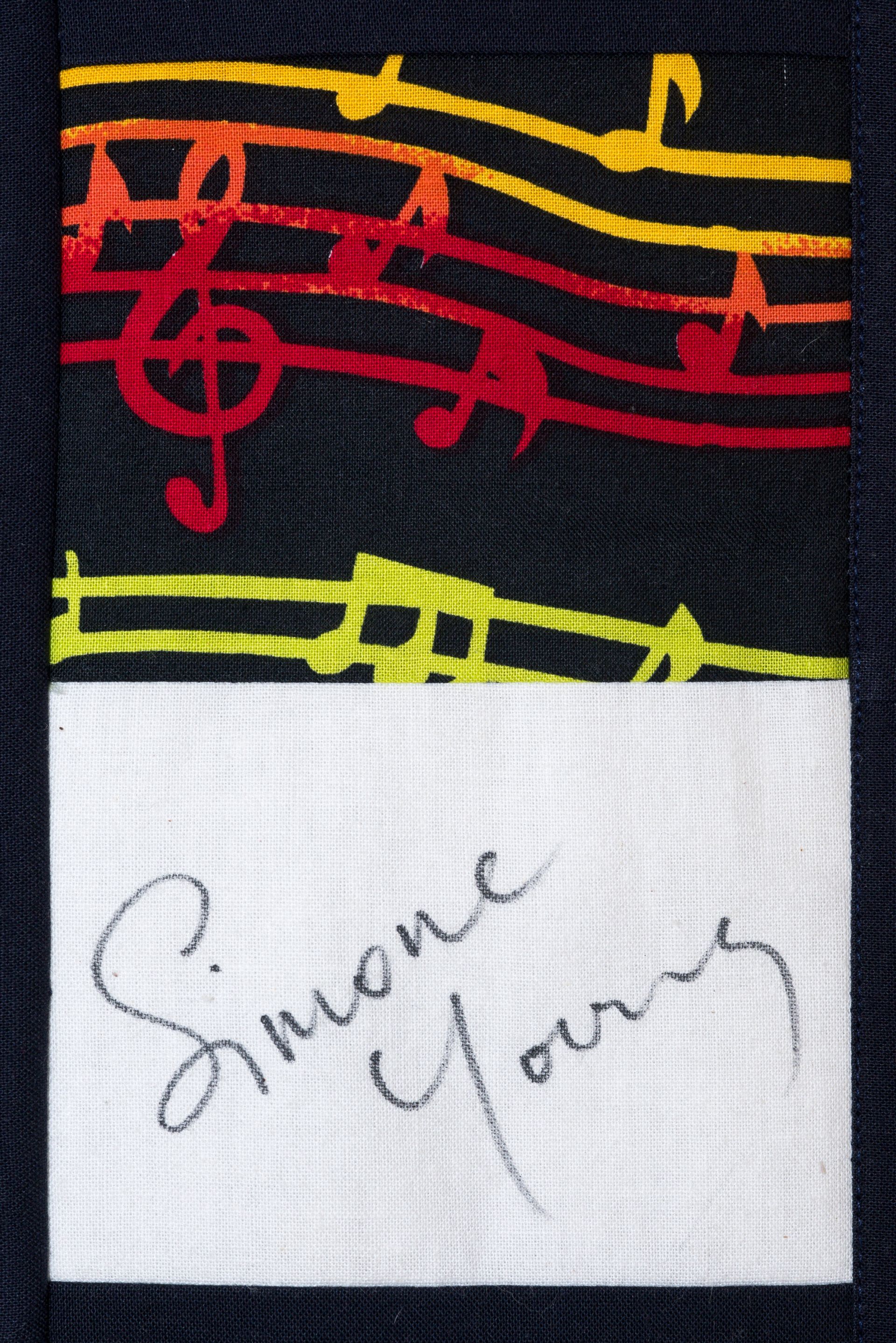 Colorful embroidered music notes above a handwritten note reading “Sharon Young”
