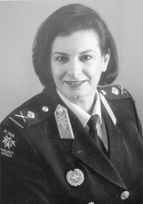 Black-and-white portrait of a uniformed officer smiling at the camera