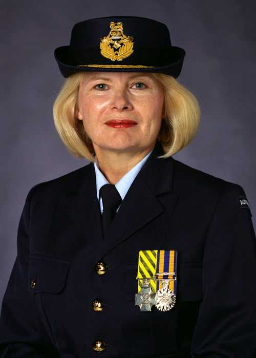 Portrait of a uniformed officer in a dark navy dress uniform with medals and a peaked cap