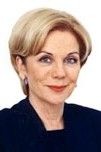 Portrait of a blonde woman with a slight smile, wearing a dark top on a white background
