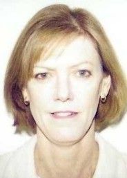 Portrait of a person with short light brown hair against a plain white background