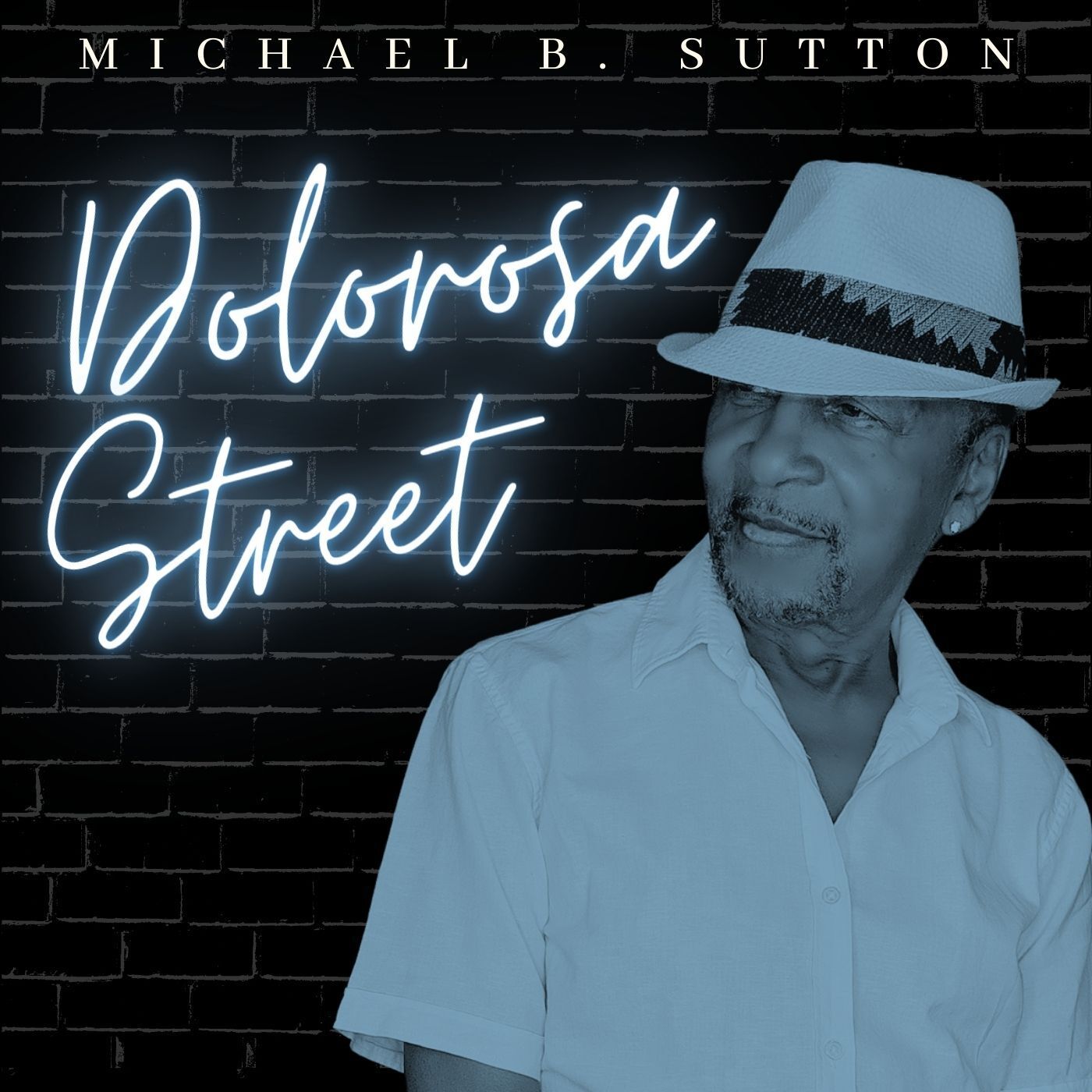 Book cover for “Dobrosa Street” by Michael B. Sutton, featuring a man in a white shirt and hat against a brick wall.