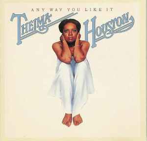 Album cover showing a person in white draped fabric, seated on a beige background, with “Them Thangs” text above.
