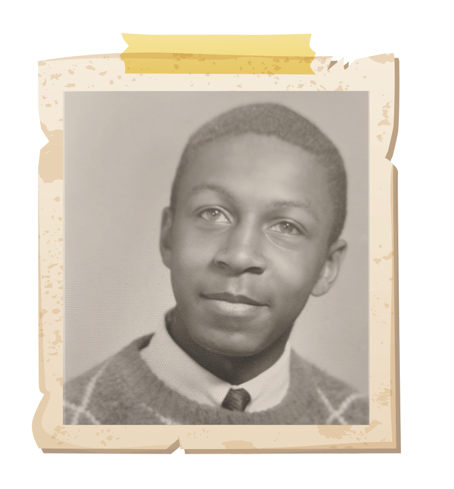 Black-and-white studio portrait of a man in a sweater and tie, mounted on a worn beige photo mat.