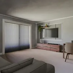 Modern living room with gray walls, sliding doors, TV, low console, and beige chair on carpet.