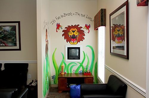 A waiting room with a lion painted on the wall.