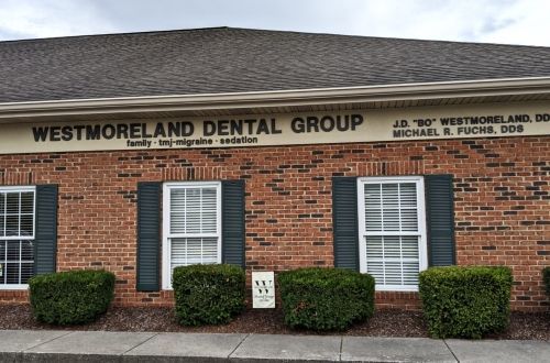 A brick building with a sign that says westmoreland dental group