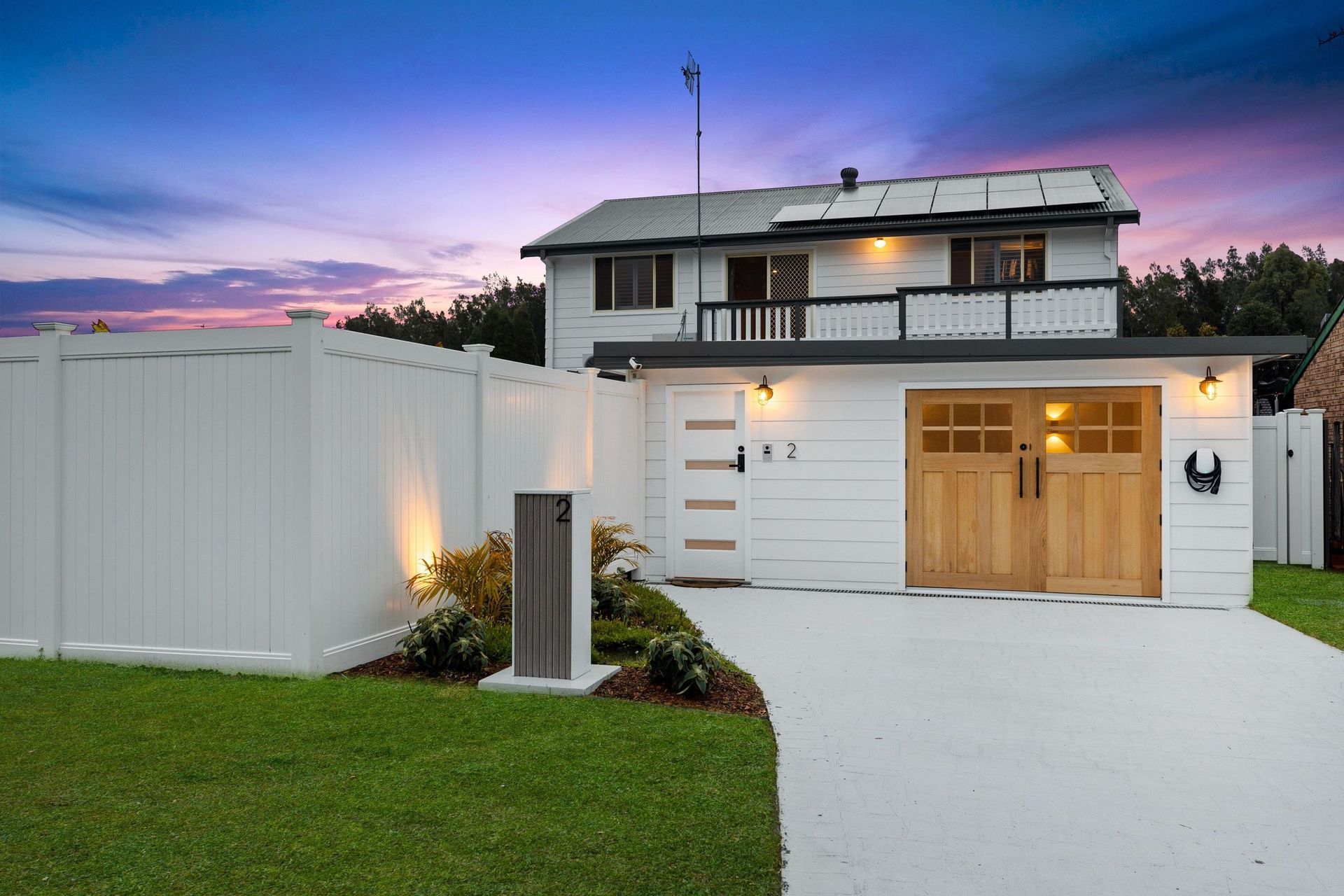A New House With A Long Driveway And Bright Lights At The Front — TB Electrical & Communications in West Gosford, NSW