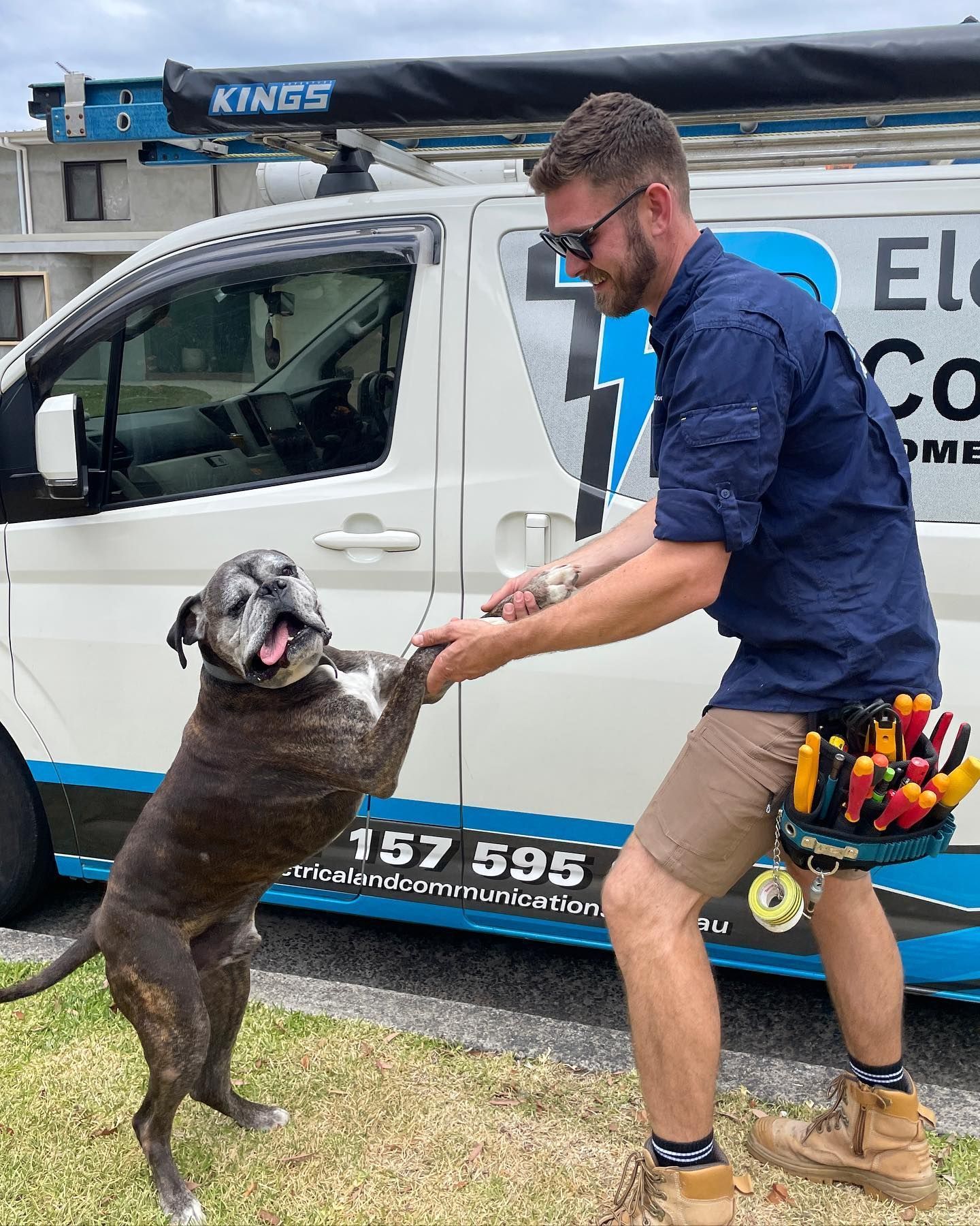 Electrician With 24hrs Service Van Playing With Friendly Dog — TB Electrical & Communications in Woy Woy, NSW