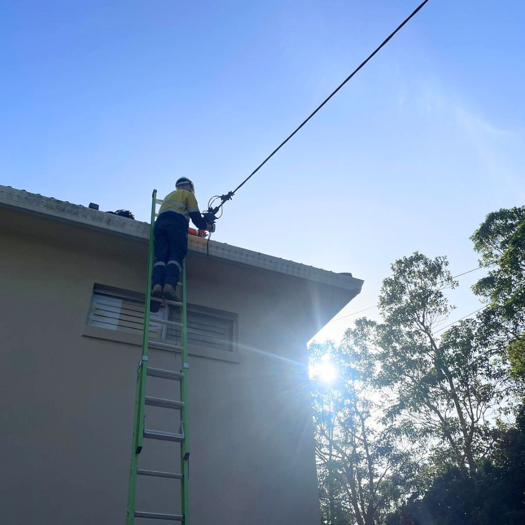 A Man Working On A Building — TB Electrical & Communications in West Gosford, NSW