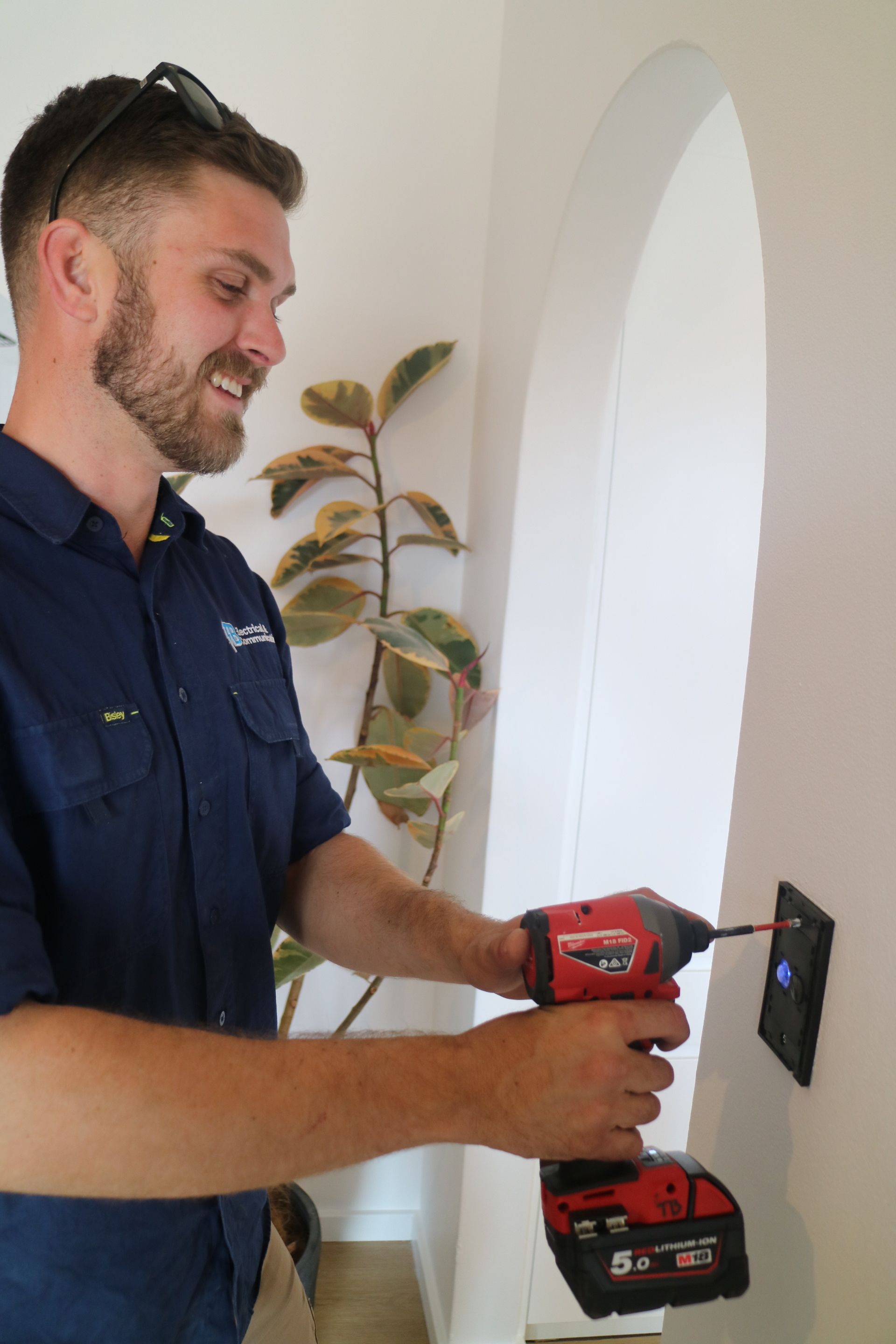 A Person is Fixing a Light switch — TB Electrical & Communications in West Gosford, NSW