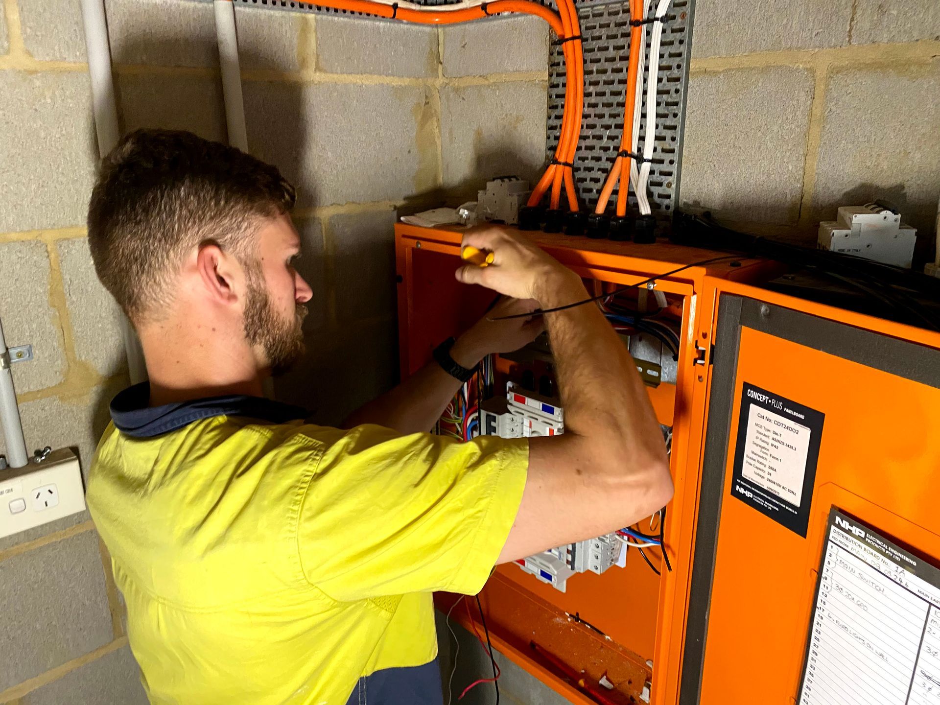 A Person is Working on an Electrical Box — TB Electrical & Communications in West Gosford, NSW