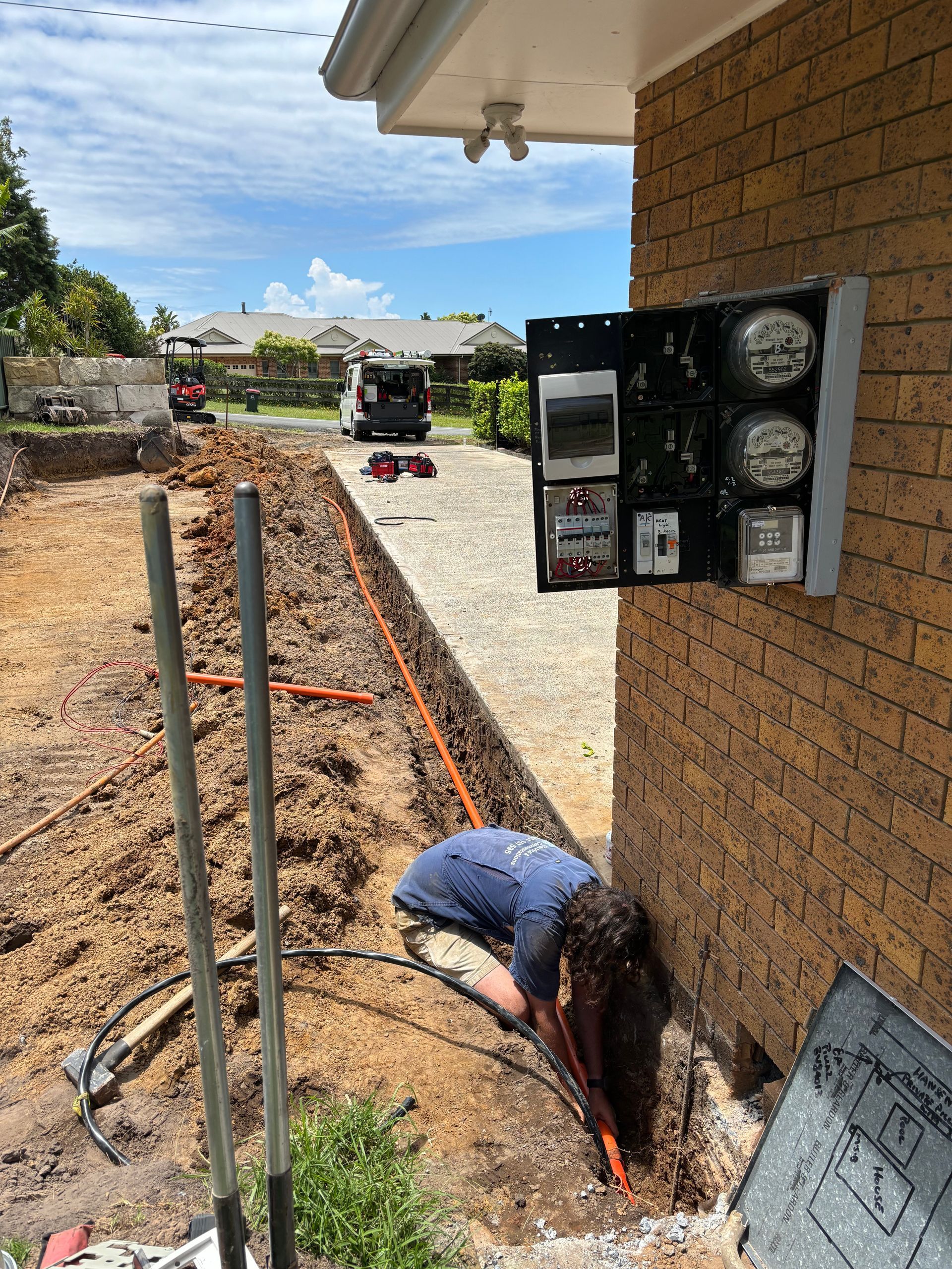 A Man Installing An Electrical Cable Underground — TB Electrical & Communications in West Gosford, NSW