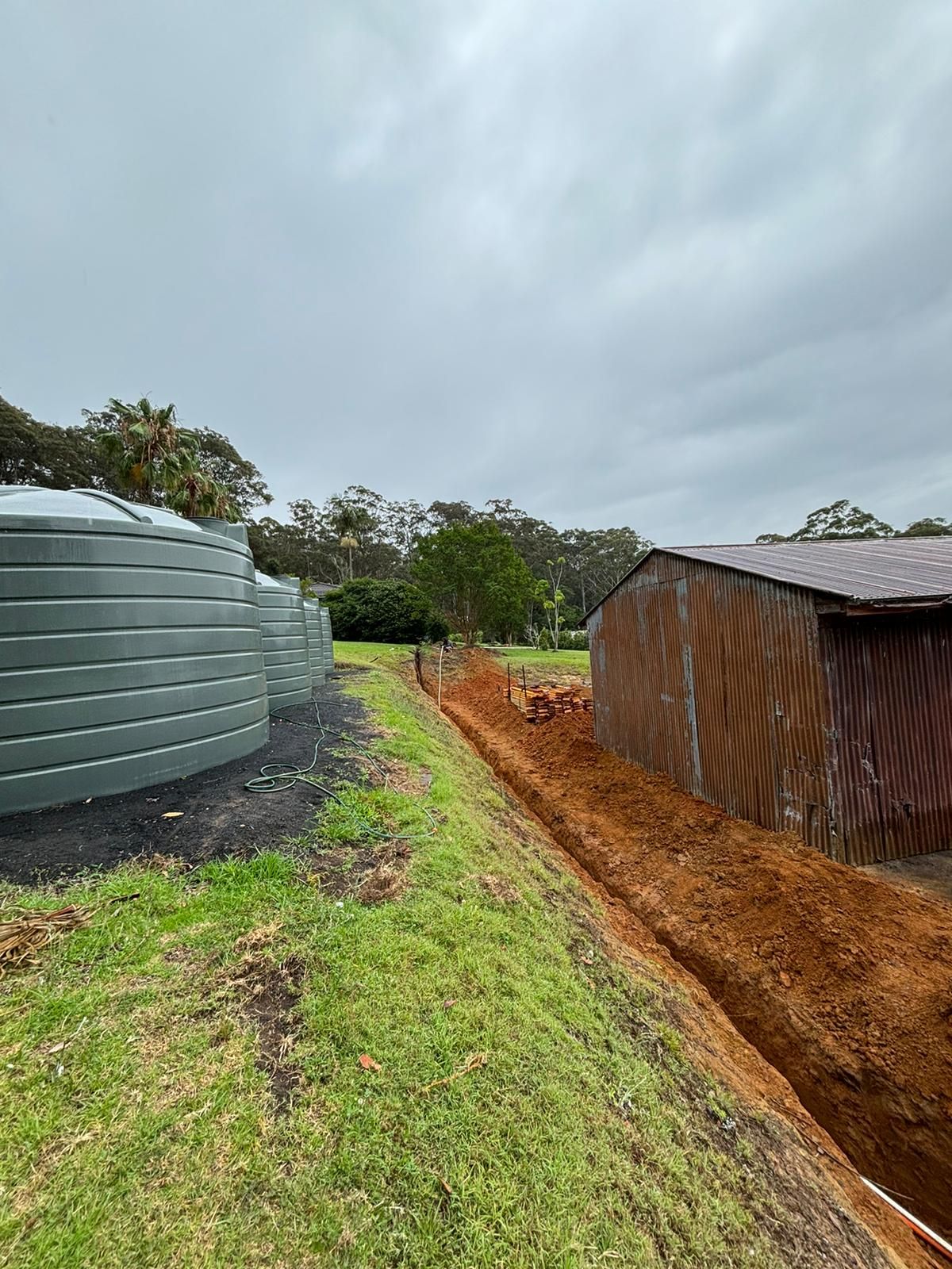 A Rural Property With A Excavated Hole And Electrical Cables Running Underground — TB Electrical & Communications in West Gosford, NSW