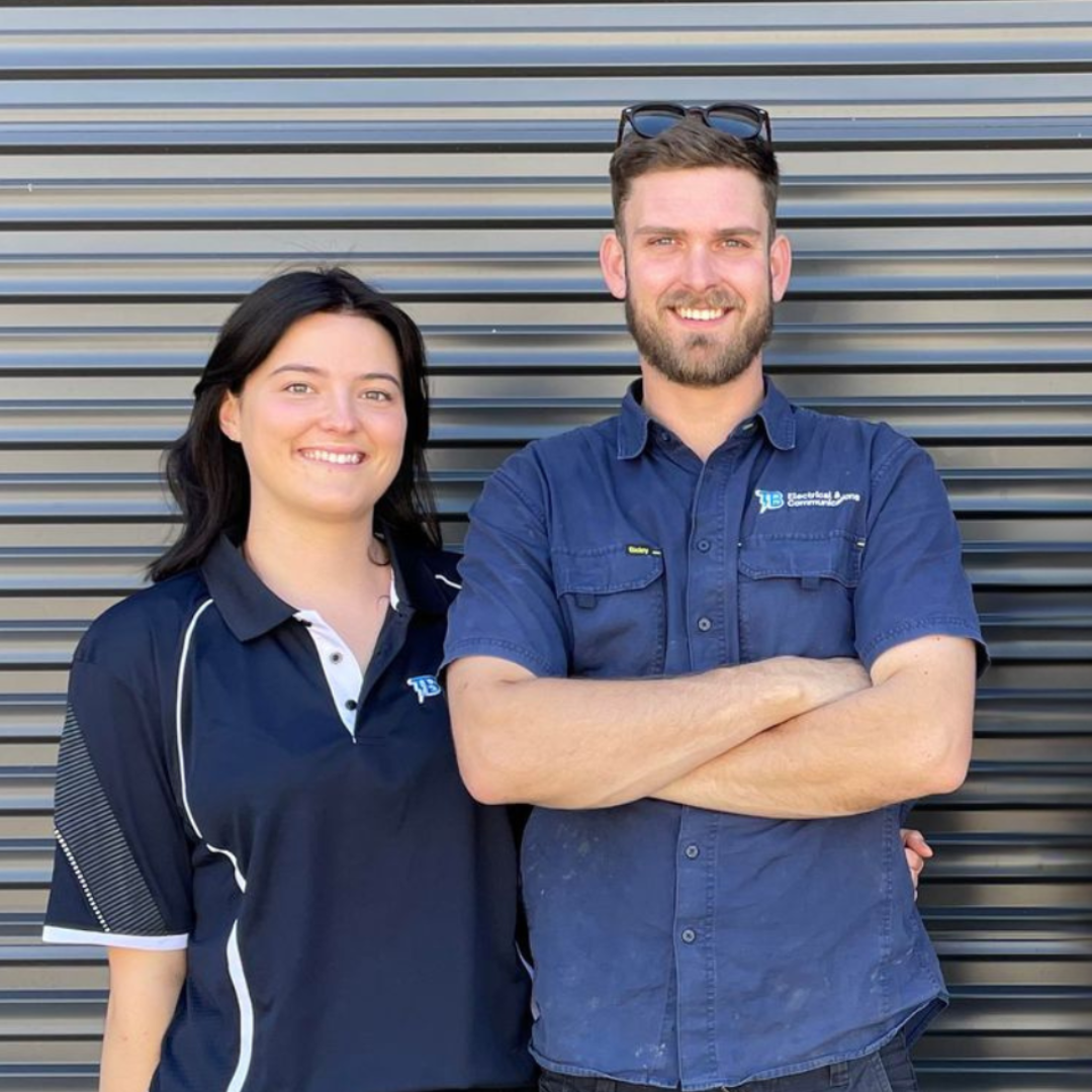A Man And A Woman Standing In Front Of A Door — TB Electrical & Communications in West Gosford, NSW