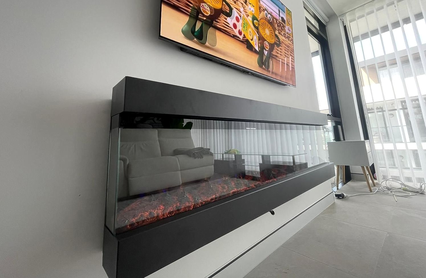 A Living Room With An Electric Fireplace — TB Electrical & Communications in West Gosford, NSW