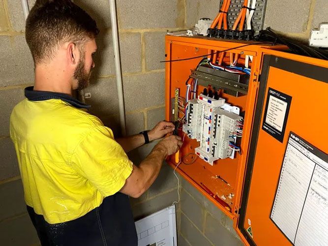 A Person working on a switchboard — TB Electrical & Communications in West Gosford, NSW