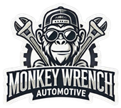 Monkey Wrench Automotive logo with a monkey in goggles and cap over crossed wrenches