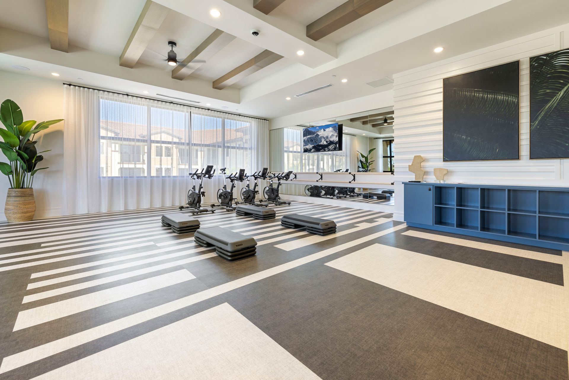 A large gym with a lot of exercise equipment and a large window at Corsa at Estero Crossing.