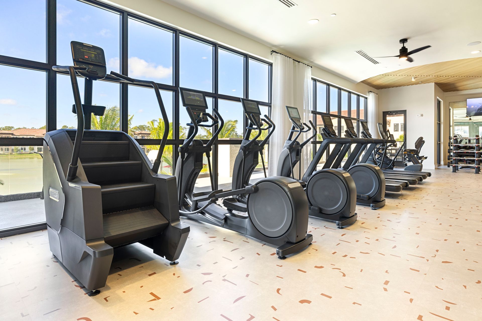 A gym with a lot of exercise equipment and stairs at Corsa at Estero Crossing.