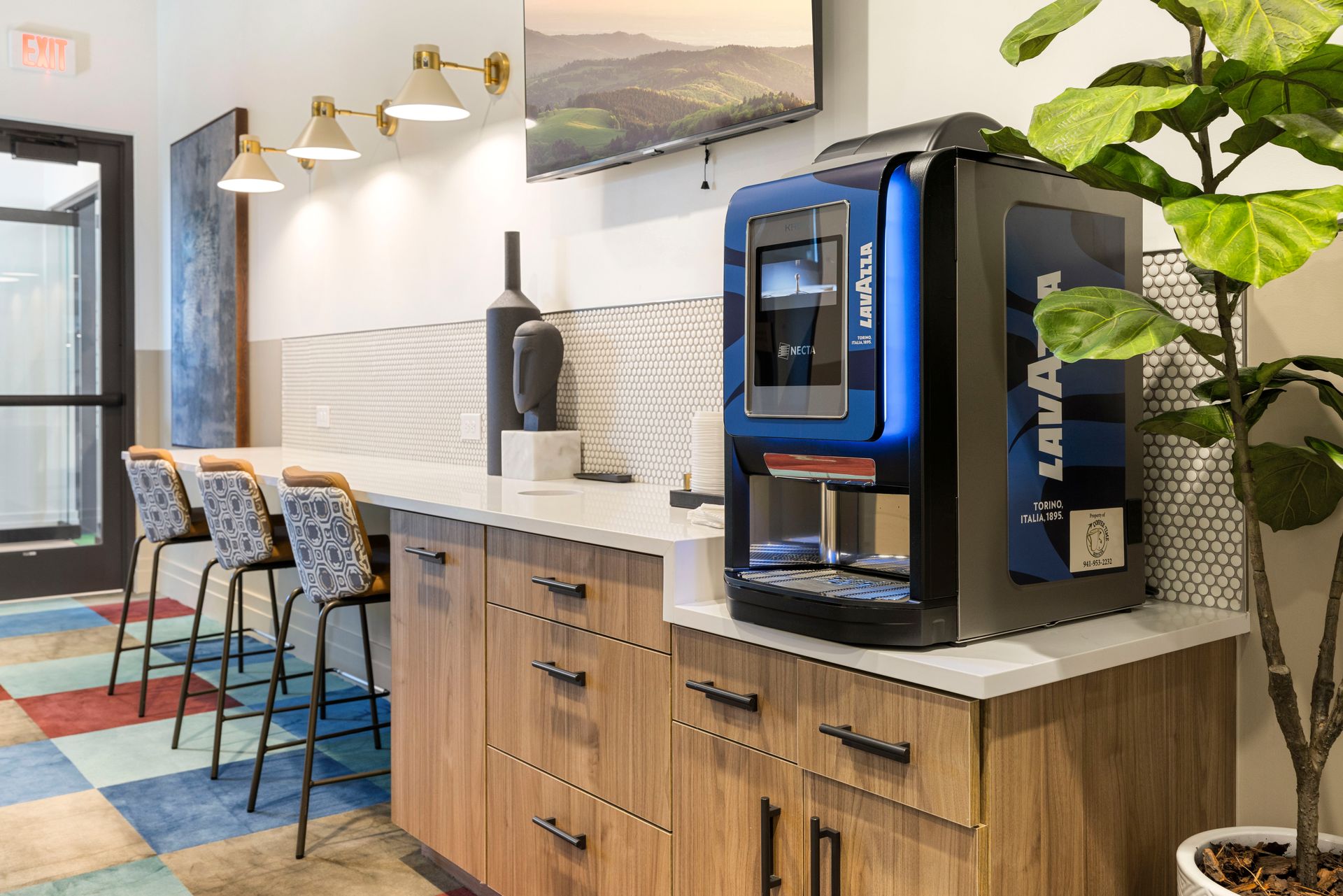 A coffee machine is sitting on a counter in a kitchen at Corsa at Estero Crossing.