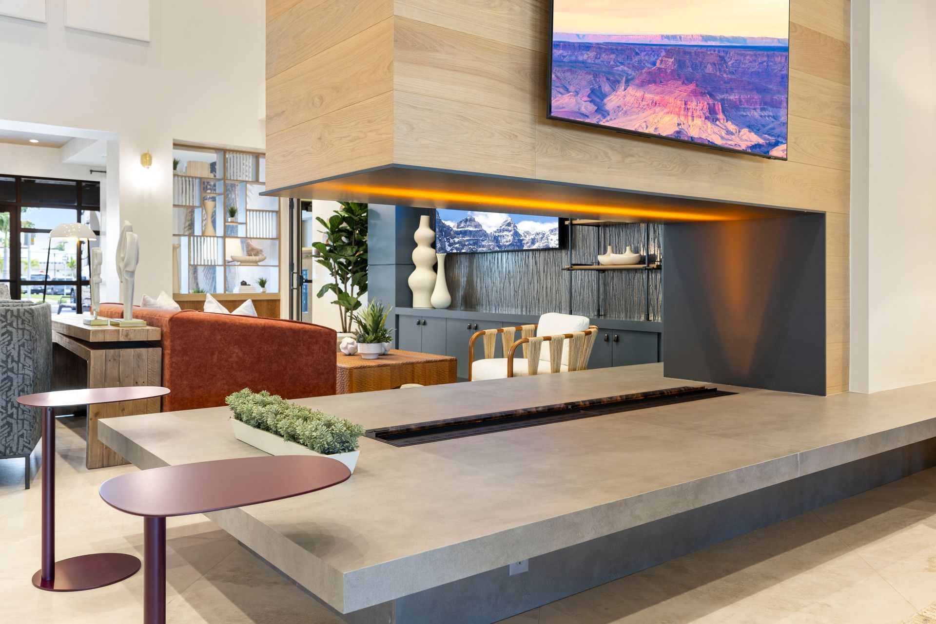 A living room with a fireplace and a flat screen tv at Corsa at Estero Crossing.