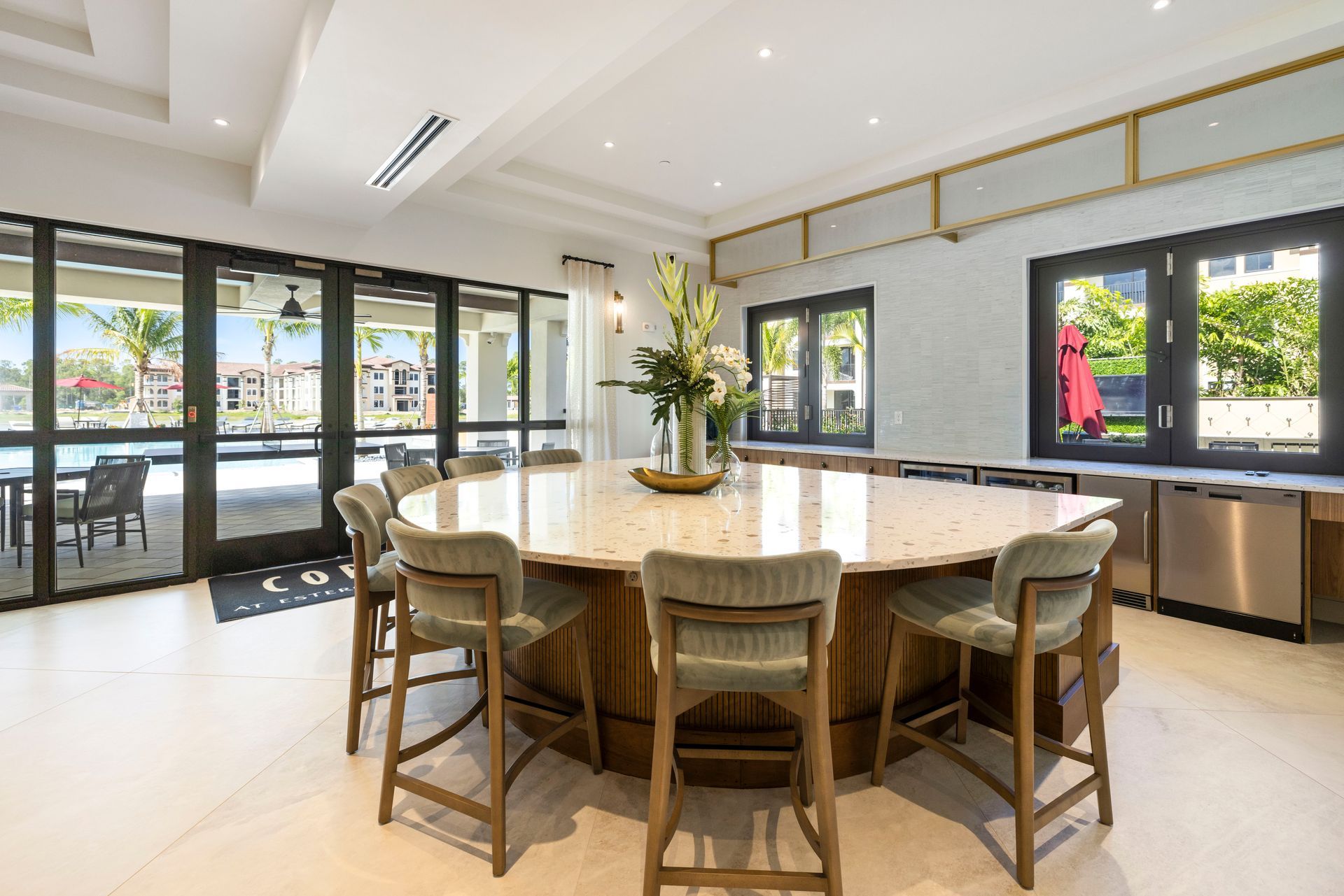 A large dining room with a round table and chairs at Corsa at Estero Crossing.