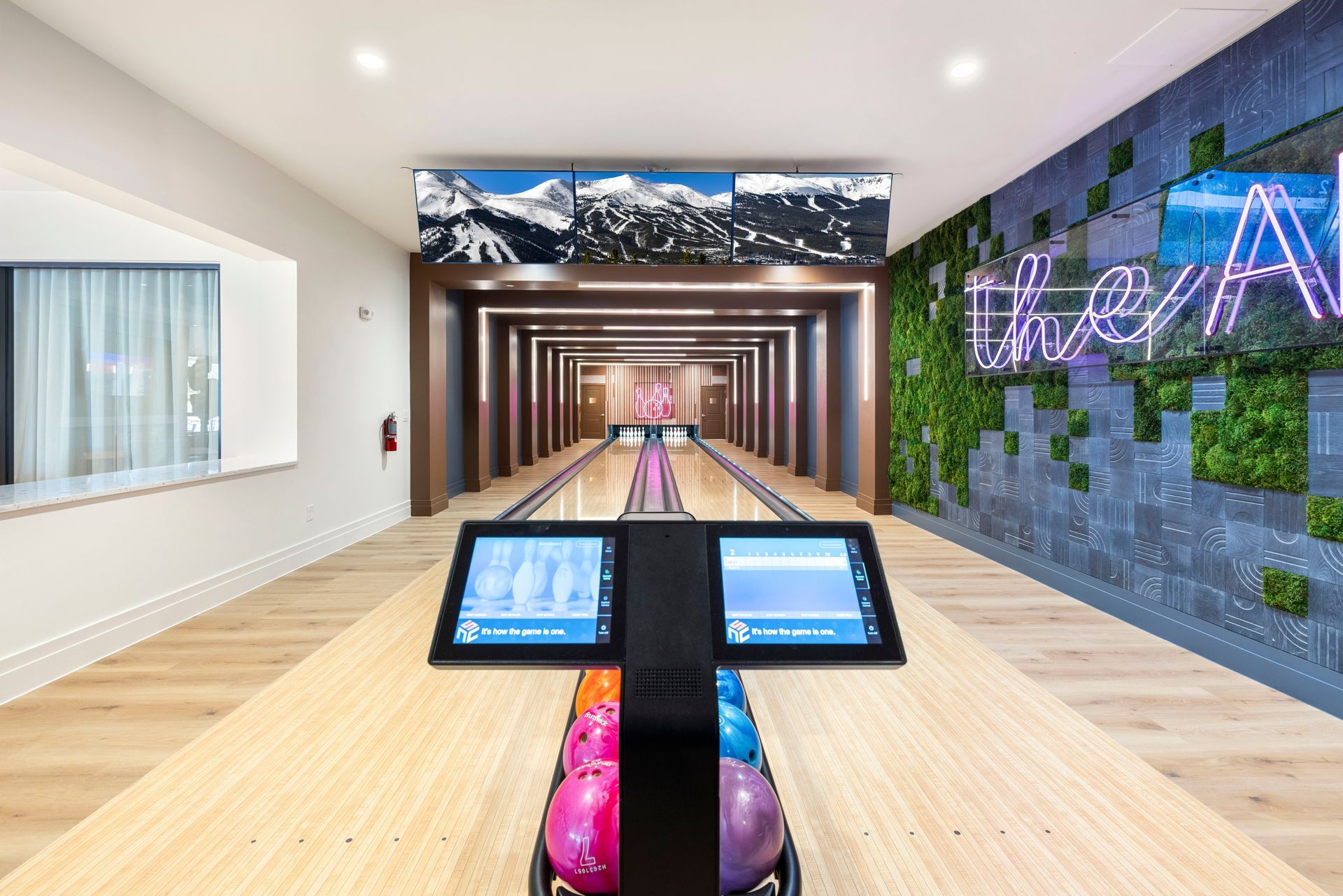 There is a bowling alley in the middle of the room at Corsa at Estero Crossing.