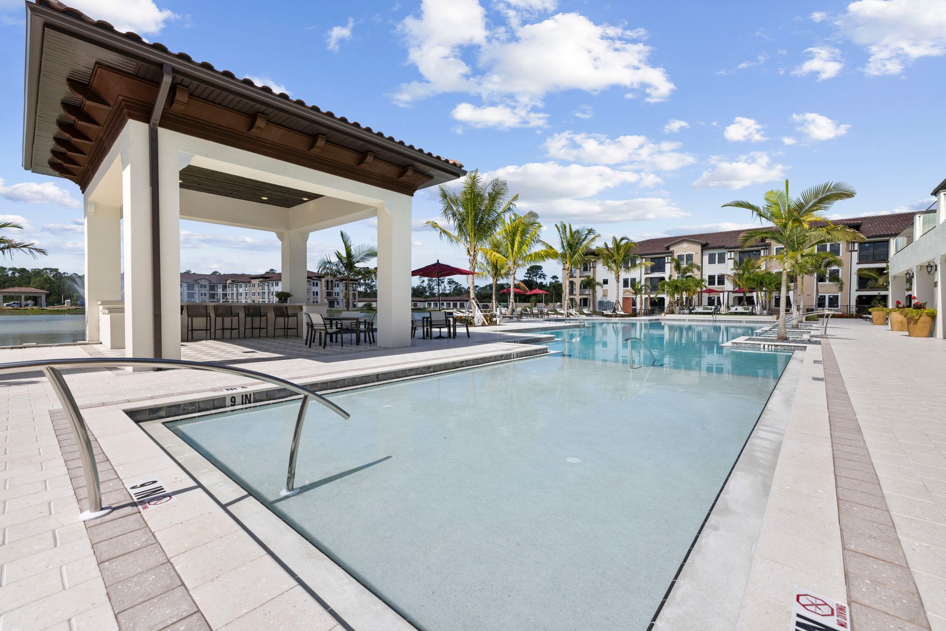 A large swimming pool with a gazebo in the background at Corsa at Estero Crossing.
