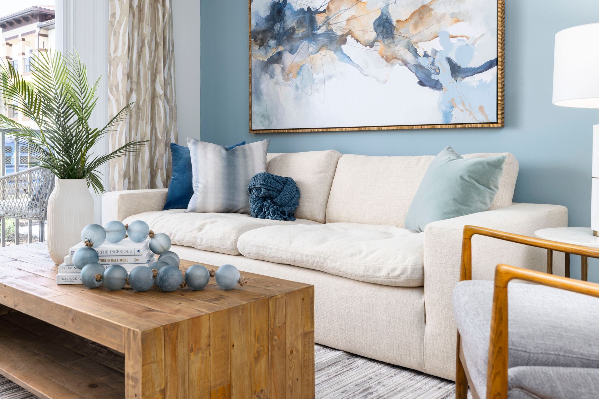 There is a painting on the wall above the couch in the living room at Corsa at Estero Crossing.
