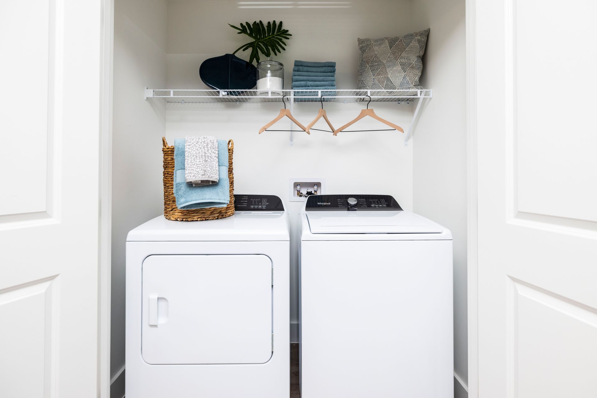 A laundry room with a washer and dryer in it at Corsa at Estero Crossing.