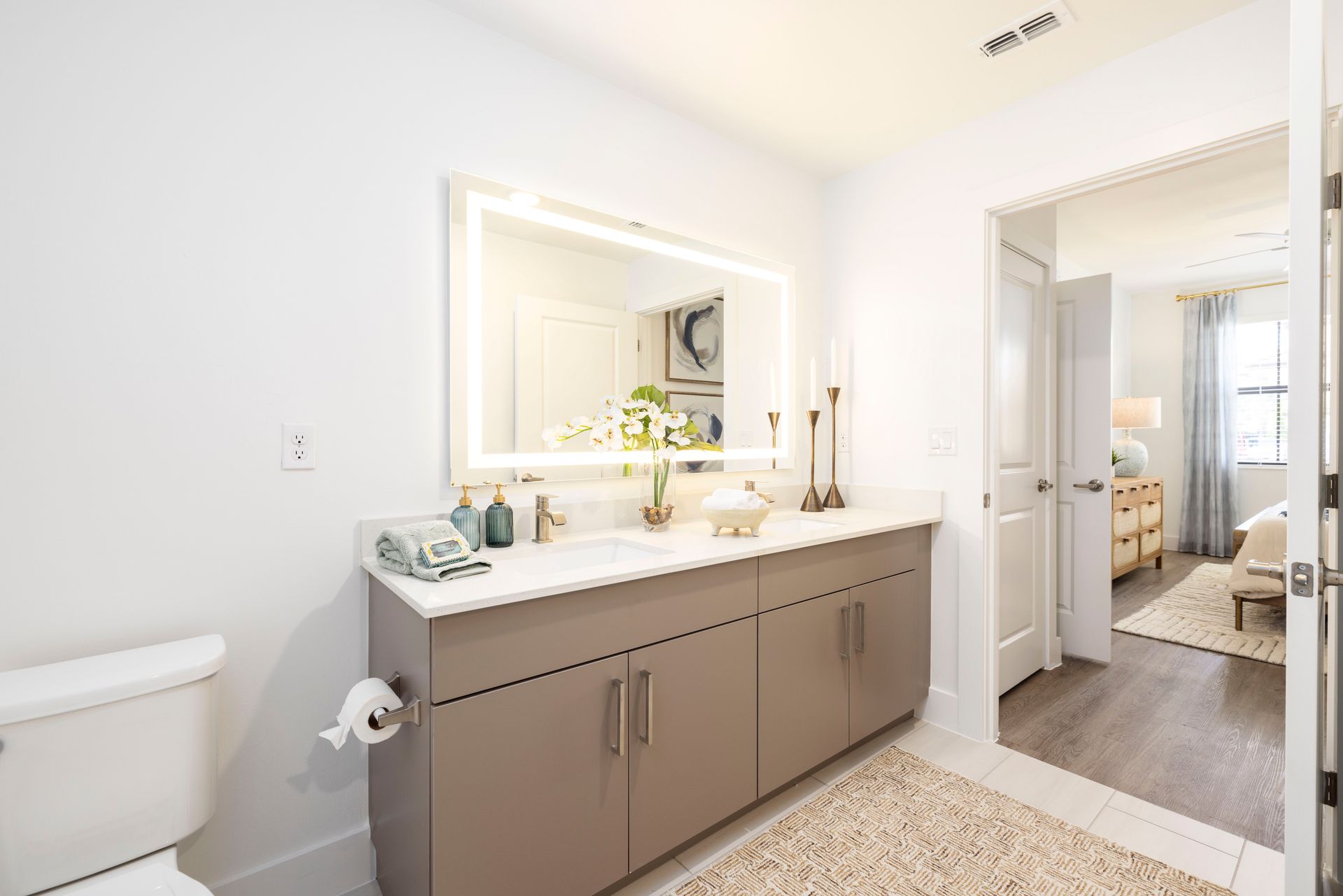 A bathroom with a toilet , sink and mirror at Corsa at Estero Crossing.