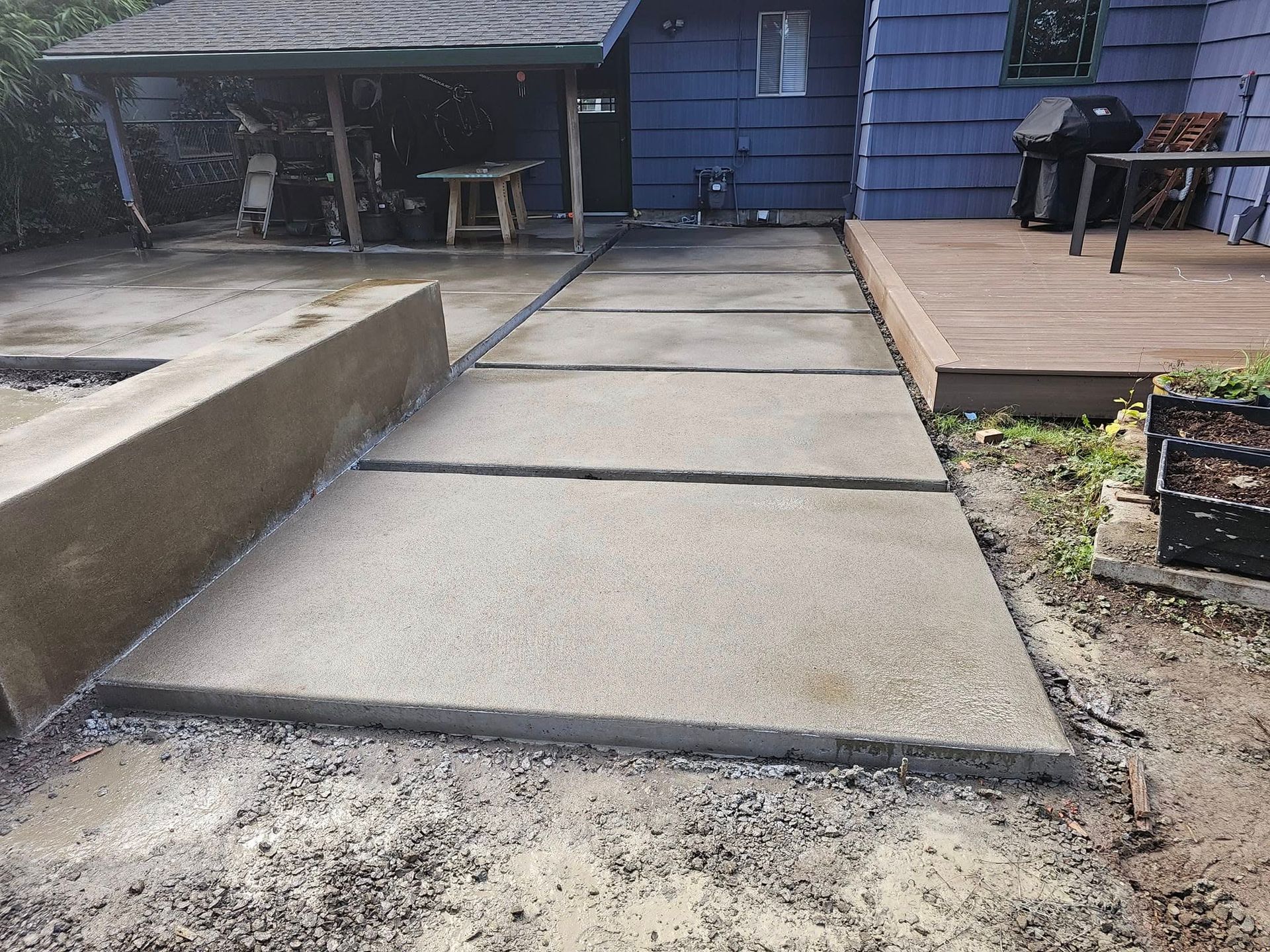 A concrete walkway leading to a purple house