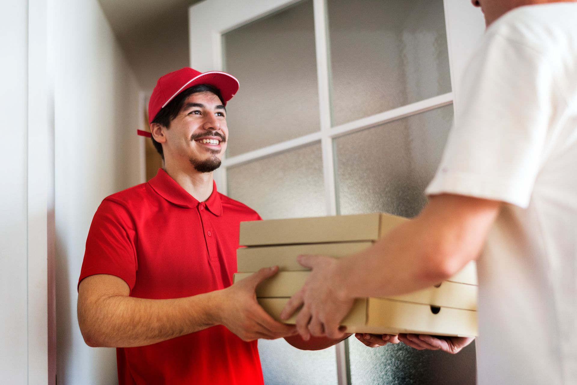 Man delivering pizza to customer.