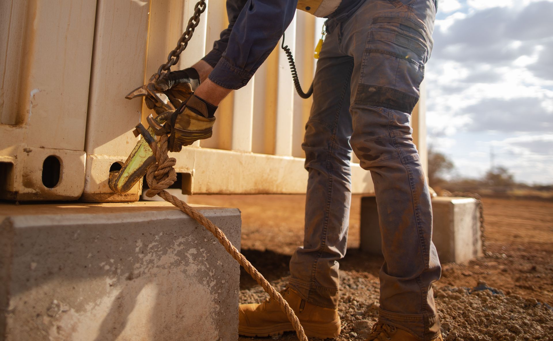  A trained rigger inspecting a lifting chain to ensure it is secure.