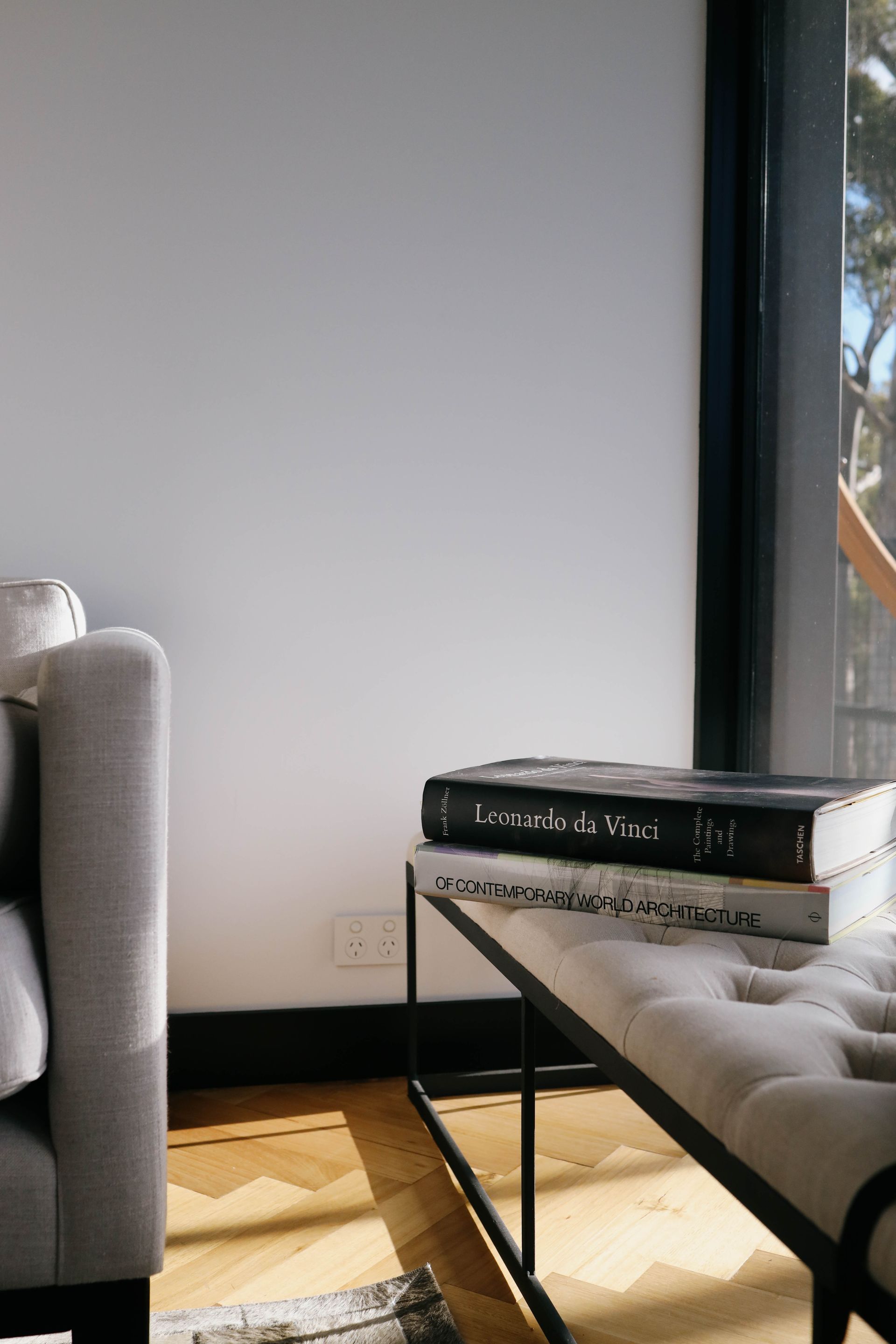 A living room with a couch and a table with books on it