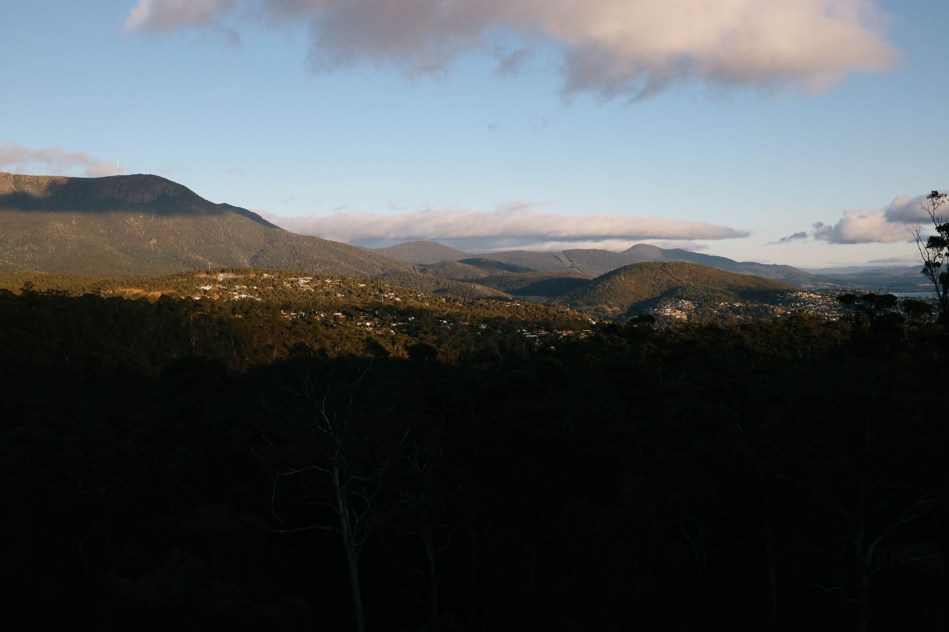 A view of a valley with mountains in the background