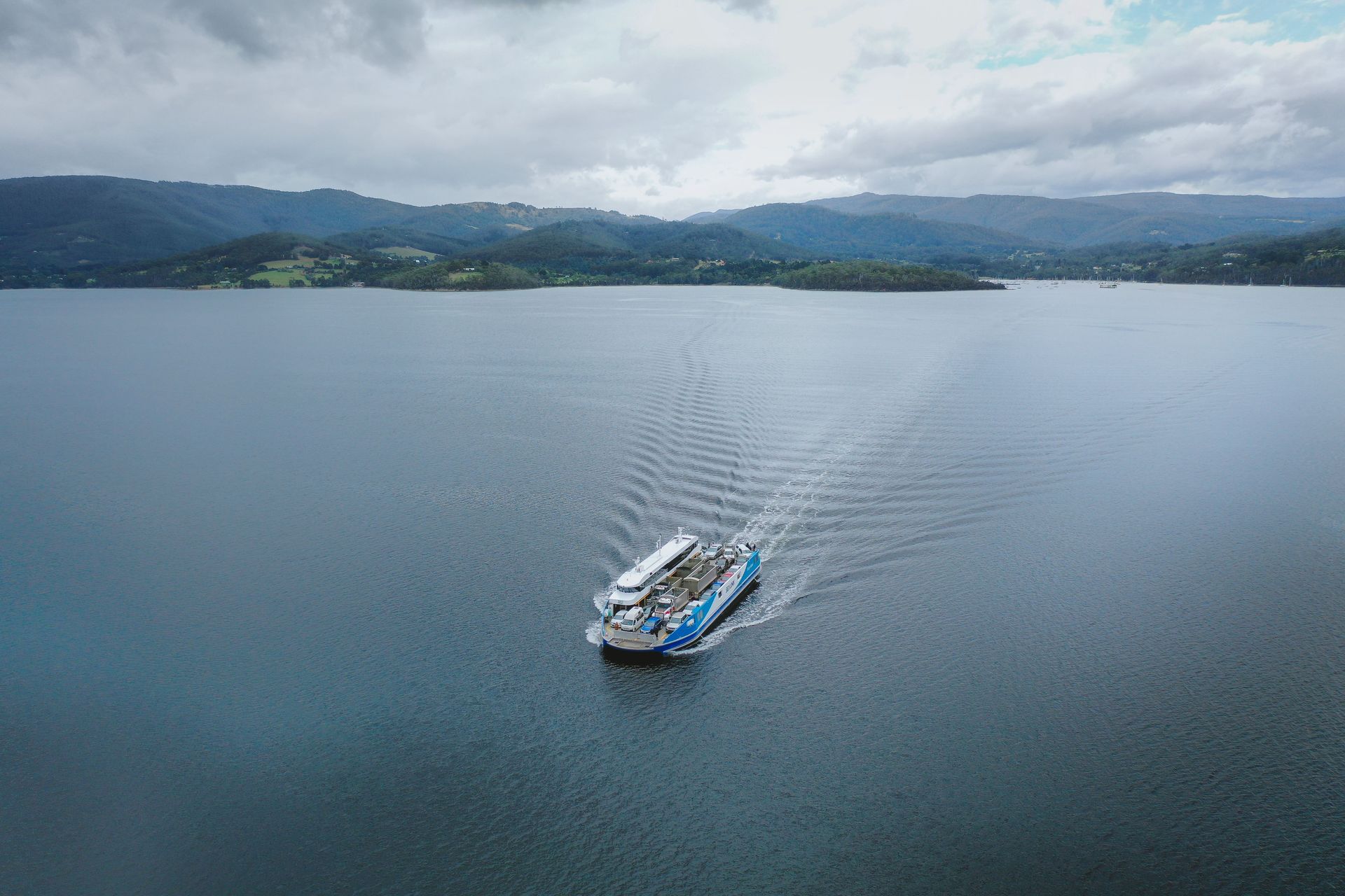 An aerial view of a boat floating on top of a large body of water.