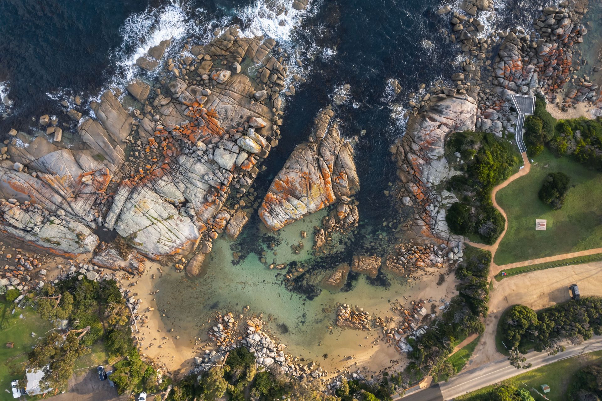 An aerial view of a rocky shoreline near the ocean