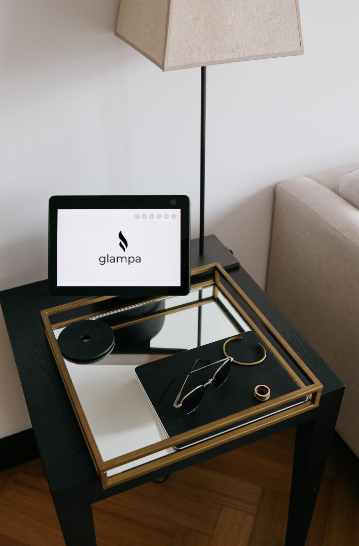 A black table with a mirrored tray and a tablet on it
