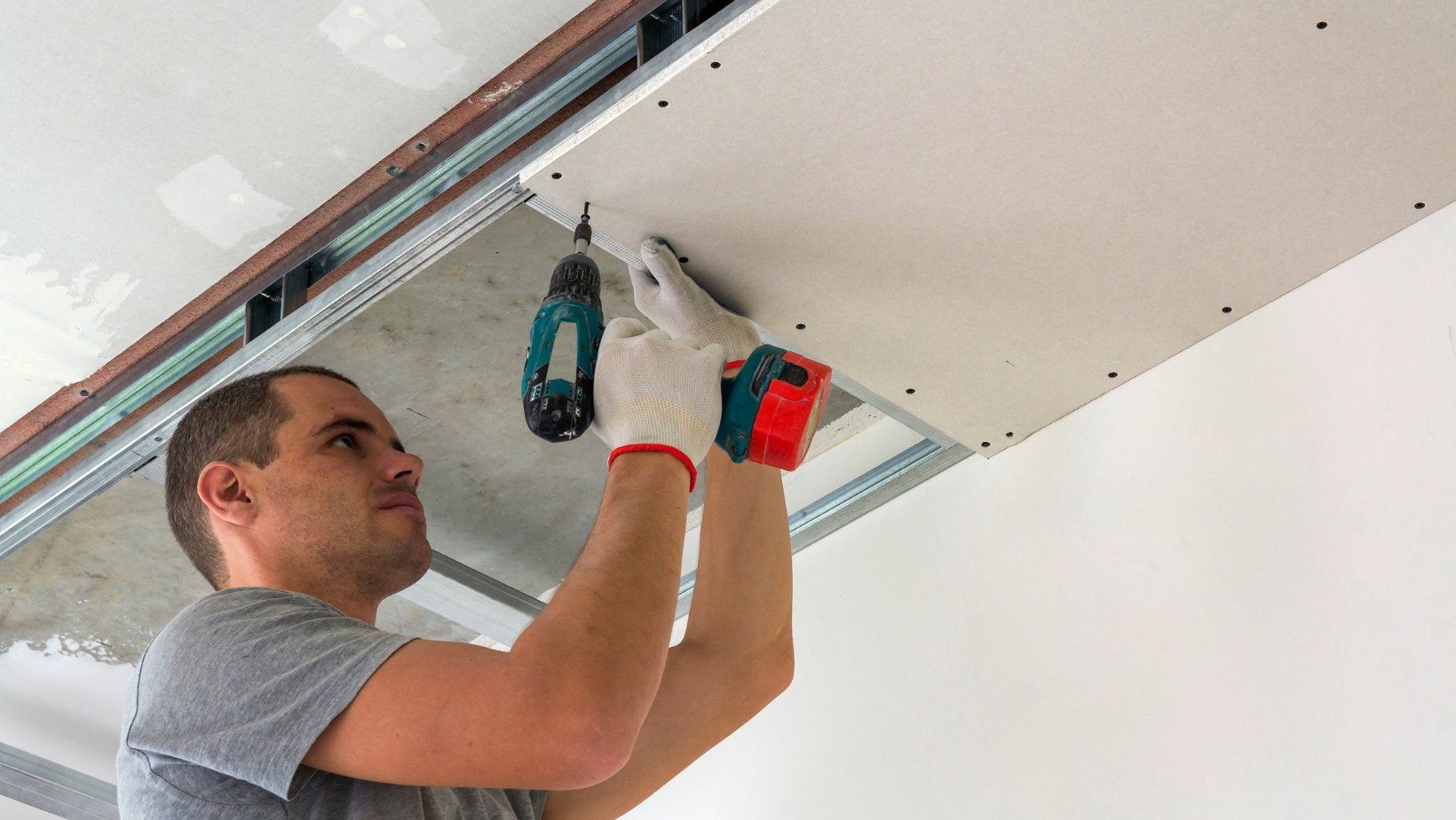 man installing drywall