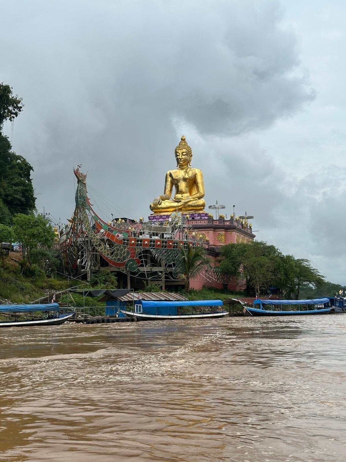 Rider with BMW motorcycle at the Golden Triangle landmark between Thailand Laos and Myanmar
