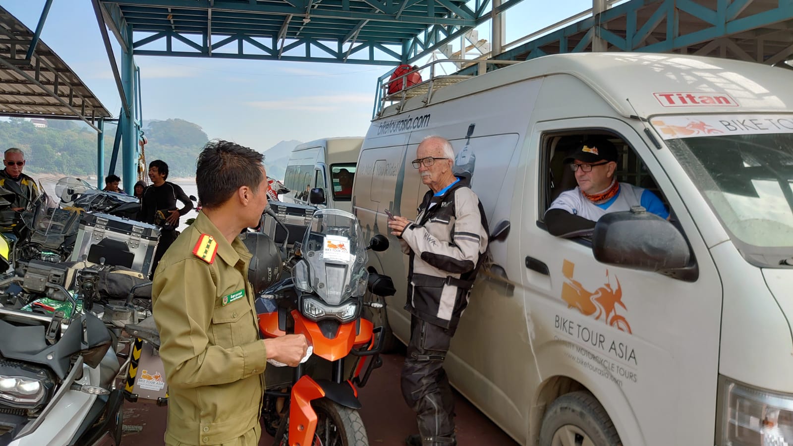 bike tour asia van and guests at Lao immigration
