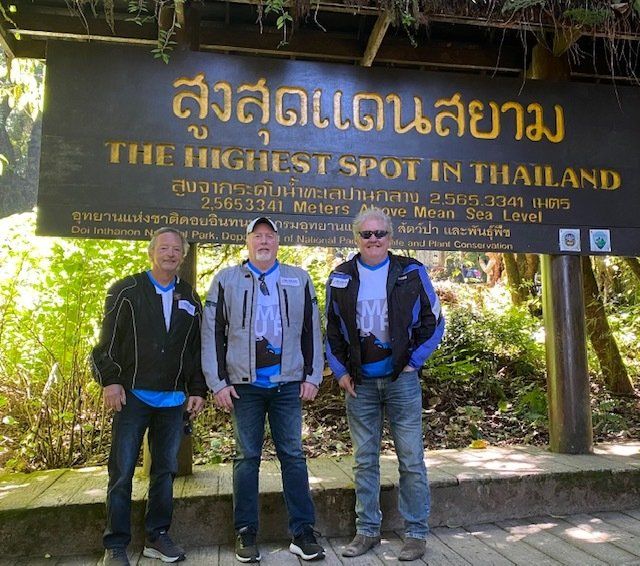 men group at the sign of doi inthanon, thailand