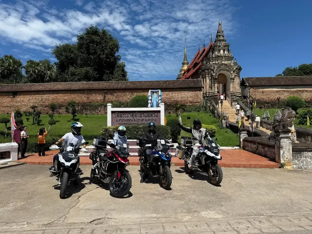 Bike Tour Asia riders with BMW motorcycles in front of Wat Phra That Lampang Luang temple in northern Thailand
