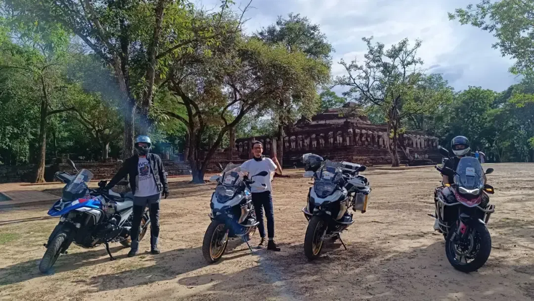 Bike Tour Asia riders with BMW motorcycles in front of Wat Phra That Lampang Luang temple in northern Thailand
