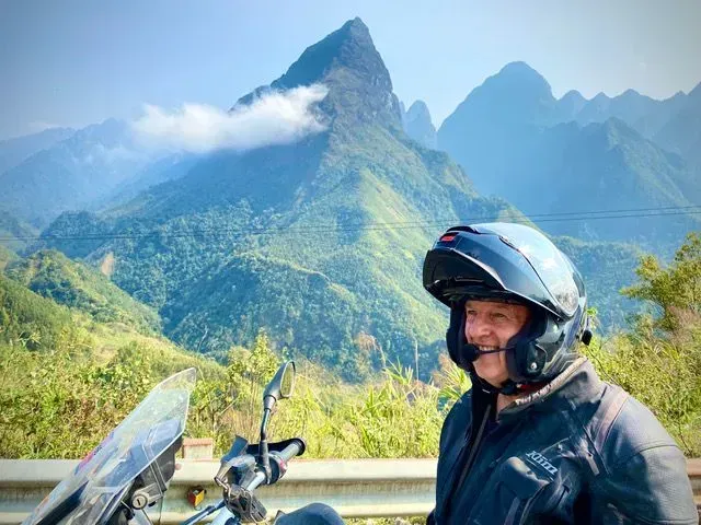 Smiling rider on scenic mountain road near Sapa, northern Vietnam