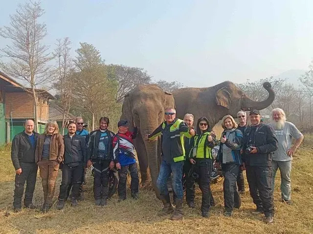 Motorcycle tour group visiting an elephant sanctuary in northern Thailand