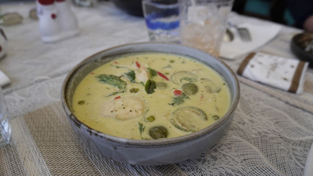 Traditional Thai green curry served during a motorcycle tour meal stop in Northern Thailand
